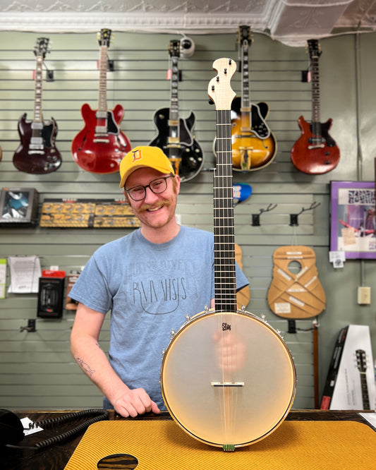 Showroom photo of Front and side of Chuck Lee Custom Lone Star 12 " Openback Banjo, Integral Wood Tone Ring