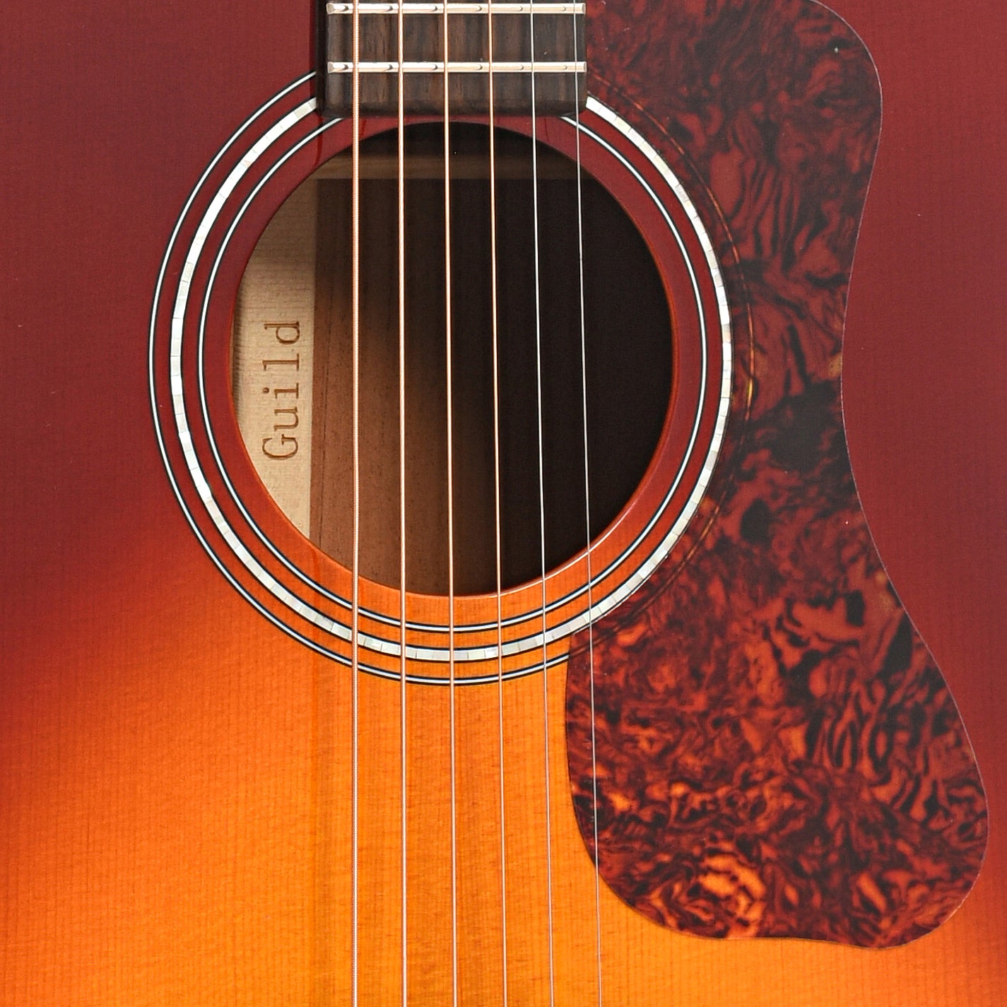 Sound hole and pickguard of Guild Westerly Collection D-140 Acoustic Guitar, Cherry Burst
