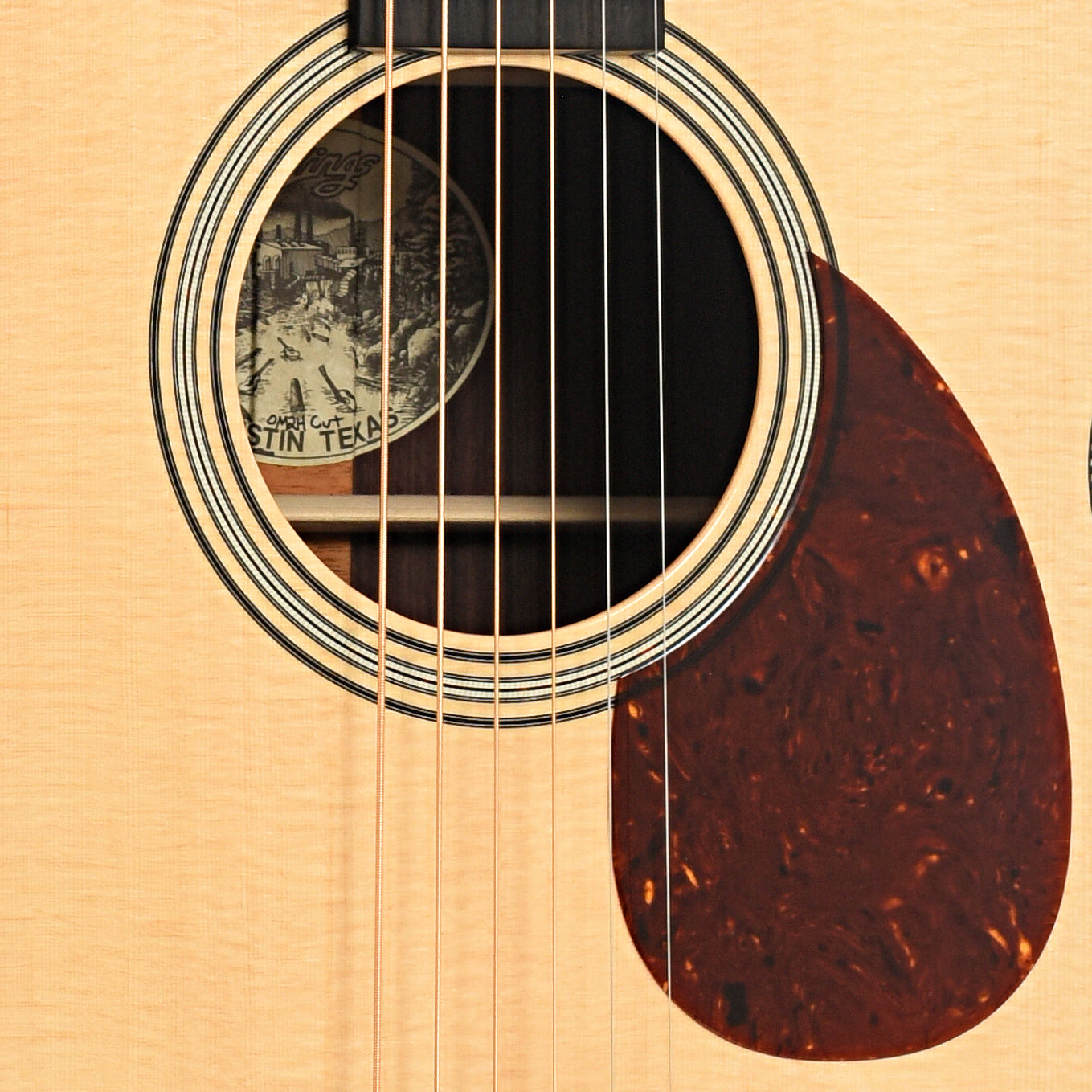 Sound hole and pickguard of Collings OM2H Cutaway Acoustic Guitar