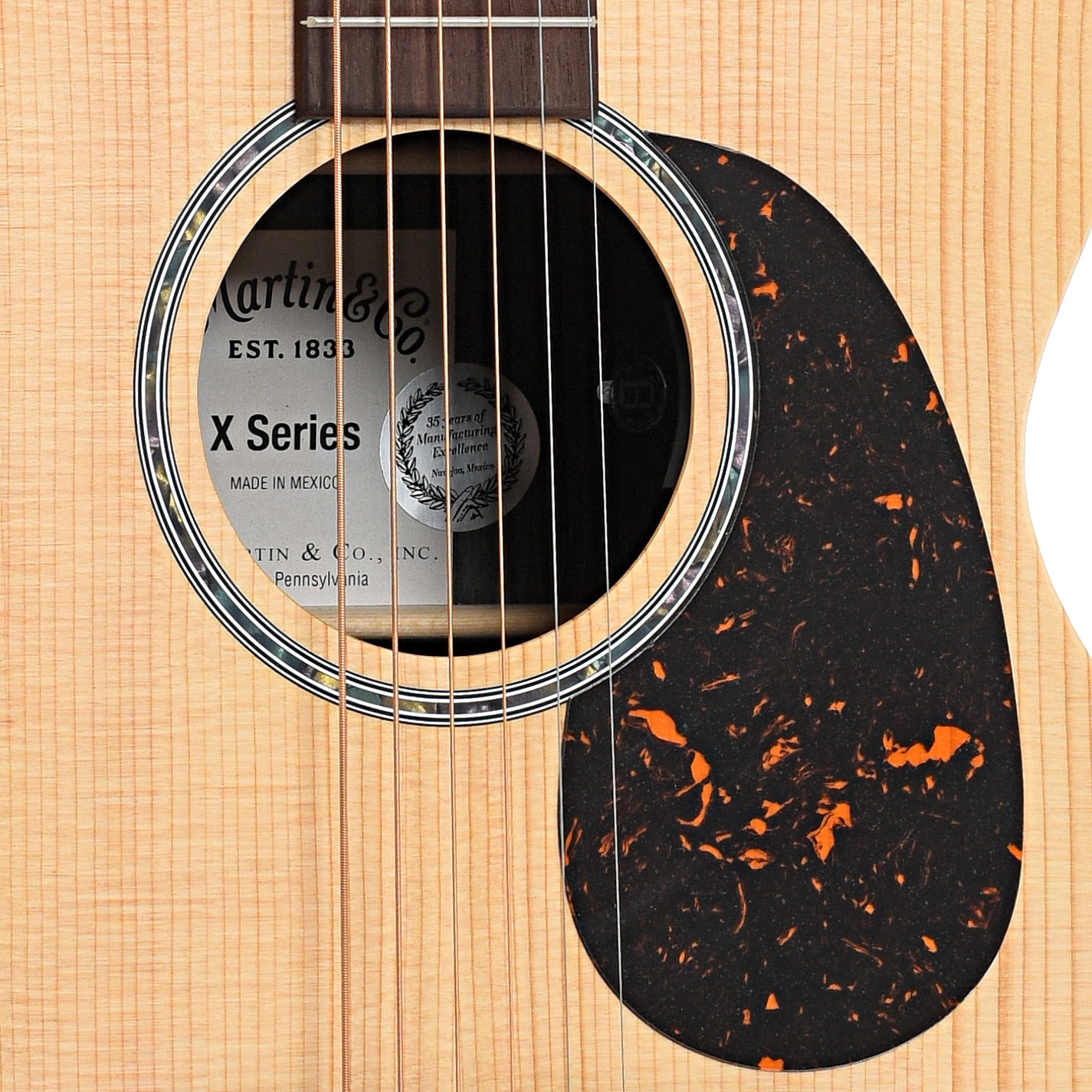 Sound hole and pickguard of Martin 00-X2E Cocobolo Acoustic Guitar 