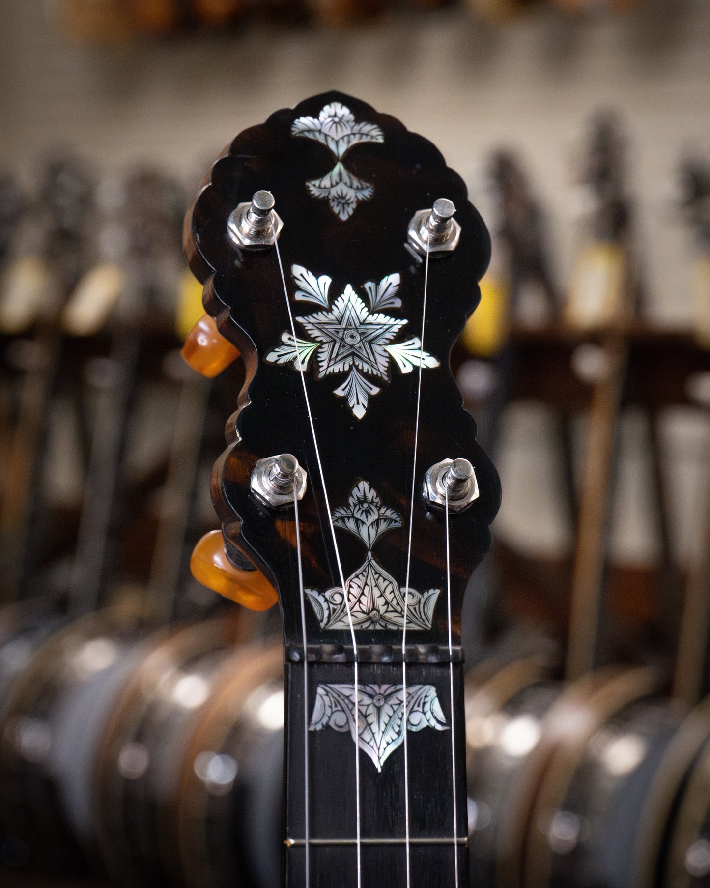 Showroom photo of headstock of Doug Unger Tubaphone Conversion Open Back Banjo (1921 / c.2005)