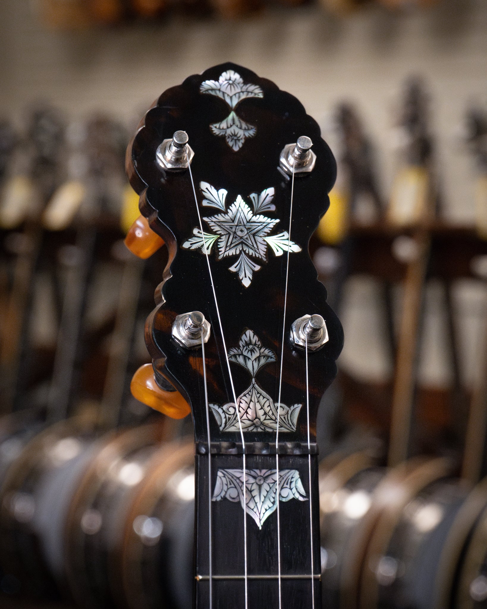 Showroom photo of headstock of Doug Unger Tubaphone Conversion Open Back Banjo (1921 / c.2005)