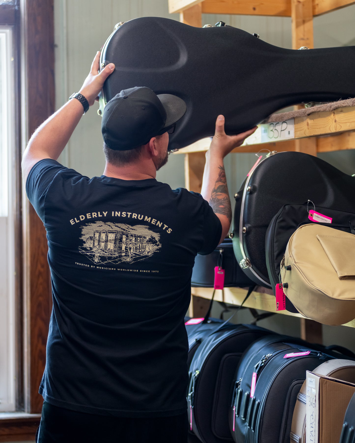 Jake wearing  and showing Back of Elderly Instruments 2-Sided Logo-Building Shirt, Black 