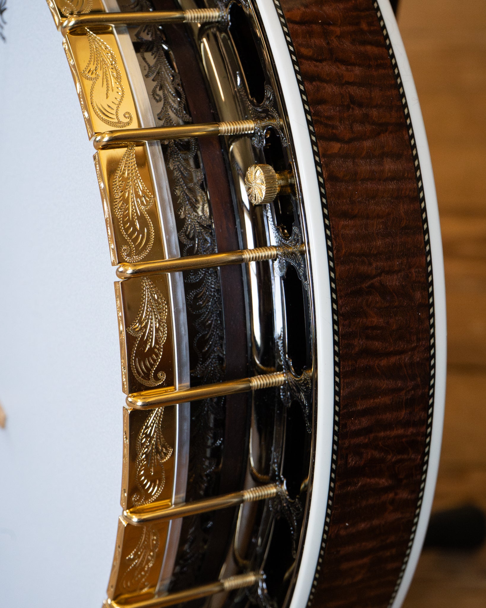 Showroom photo of rim of Capek Allegoria Gold Resonator Banjo & Case, Flame Maple