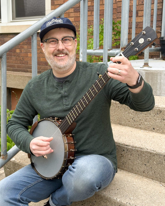 Showroom photo of Ode Magician 11in Walnut Openback Banjo & Gigbag