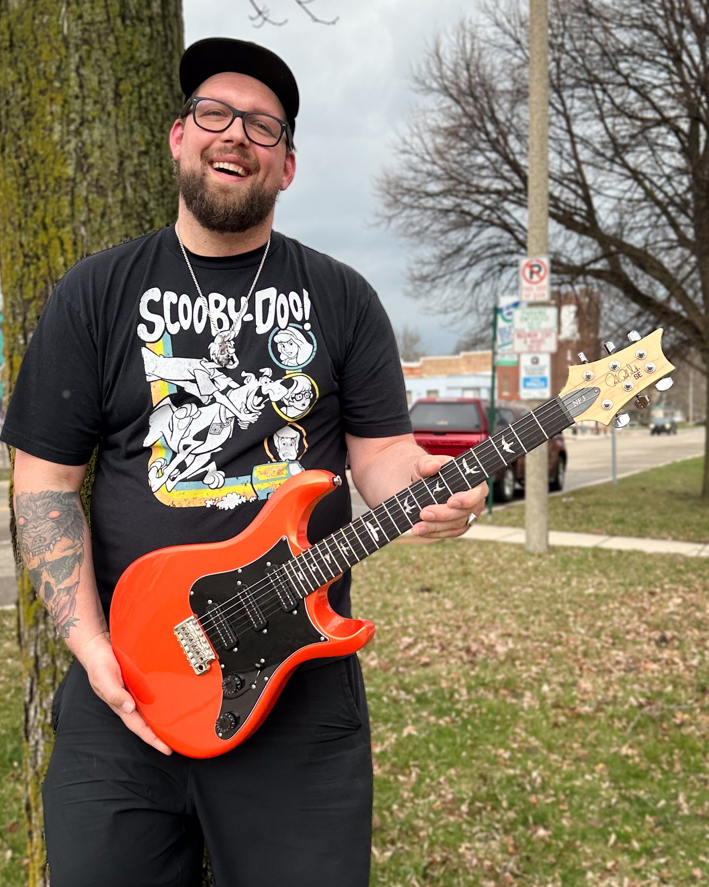 Showroom photo of PRS SE NF3 Electric Guitar, Rosewood, Metallic Orange