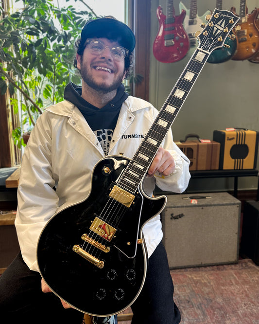 Showroom photo of Epiphone IGC Les Paul Custom Electric Guitar & Case, Ebony