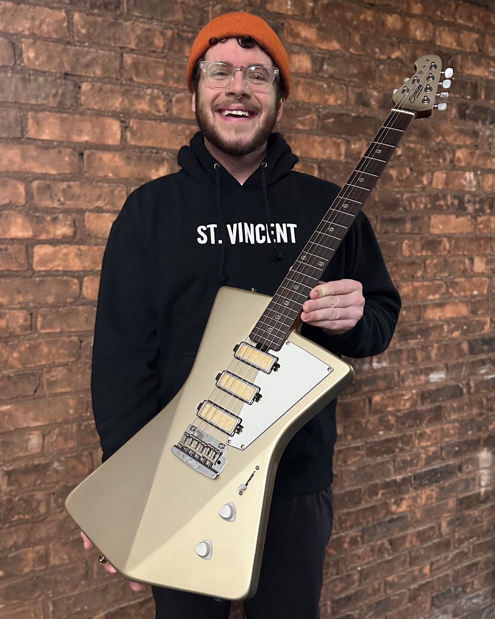 Showroom photo of Sterling by Music Man St. Vincent Goldie Electric Guitar, Cashmere