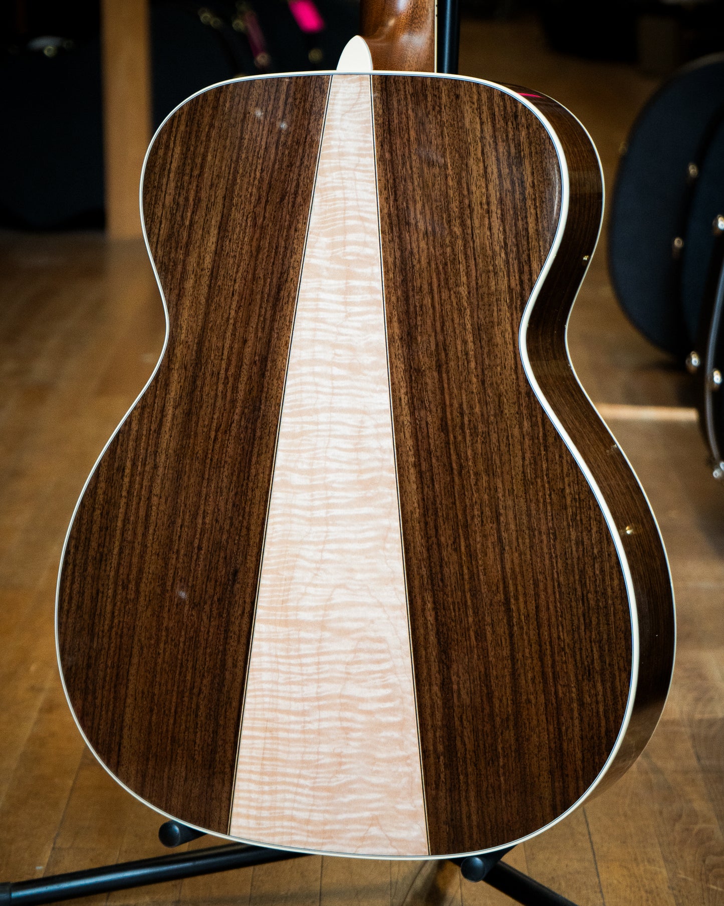 Showroom photo of back of Martin Custom M-Body Rosewood & Maple Guitar & Case