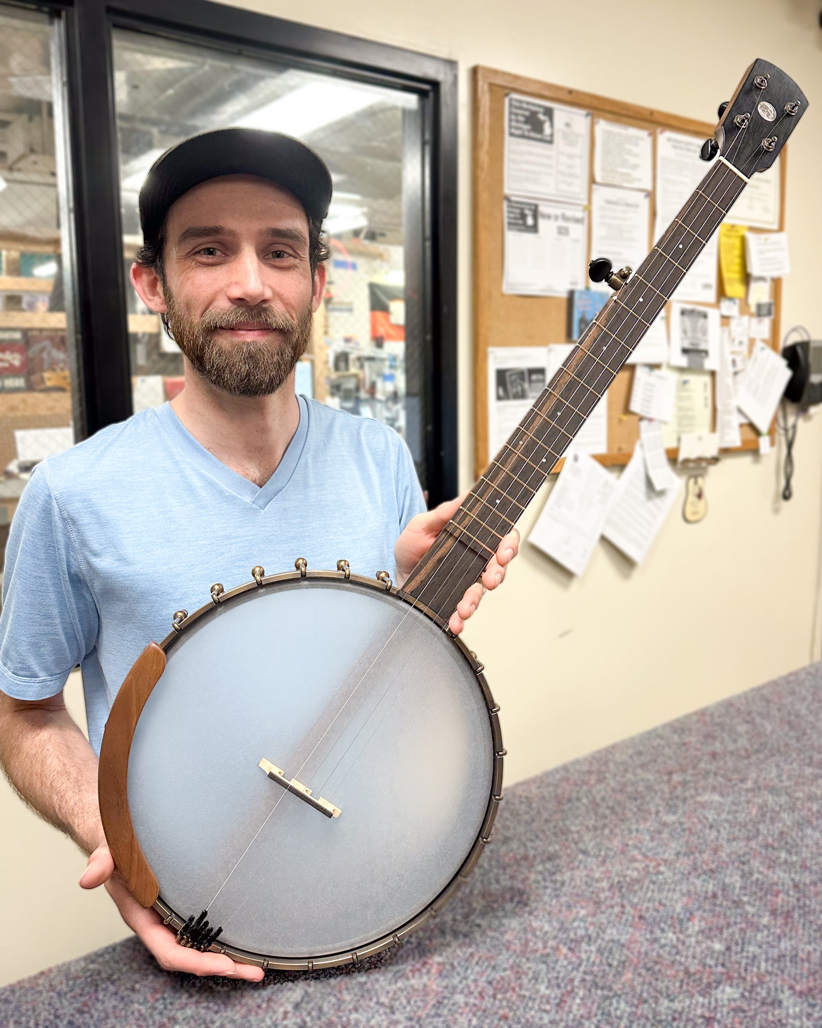 Showroom photo of Ode Magician 12in Walnut Openback Banjo & Gigbag