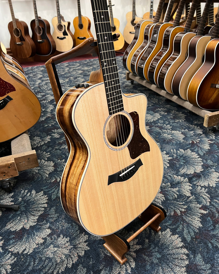 Front and Side of Taylor  214ce-K Deluxe Acoustic Guitar in showroom