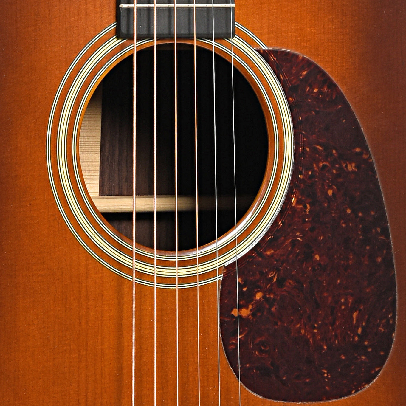 Sound hole and pickguard of Front of Martin Custom D-28 Authentic 1937 Aged Ambertone